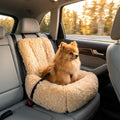 Pomeranian safely harnessed in apricot CradlePetss car mounted dog bed while car travels at highway speed